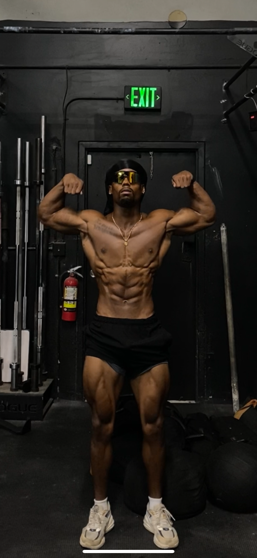 Athlete training in a dark gym with coral accent lighting